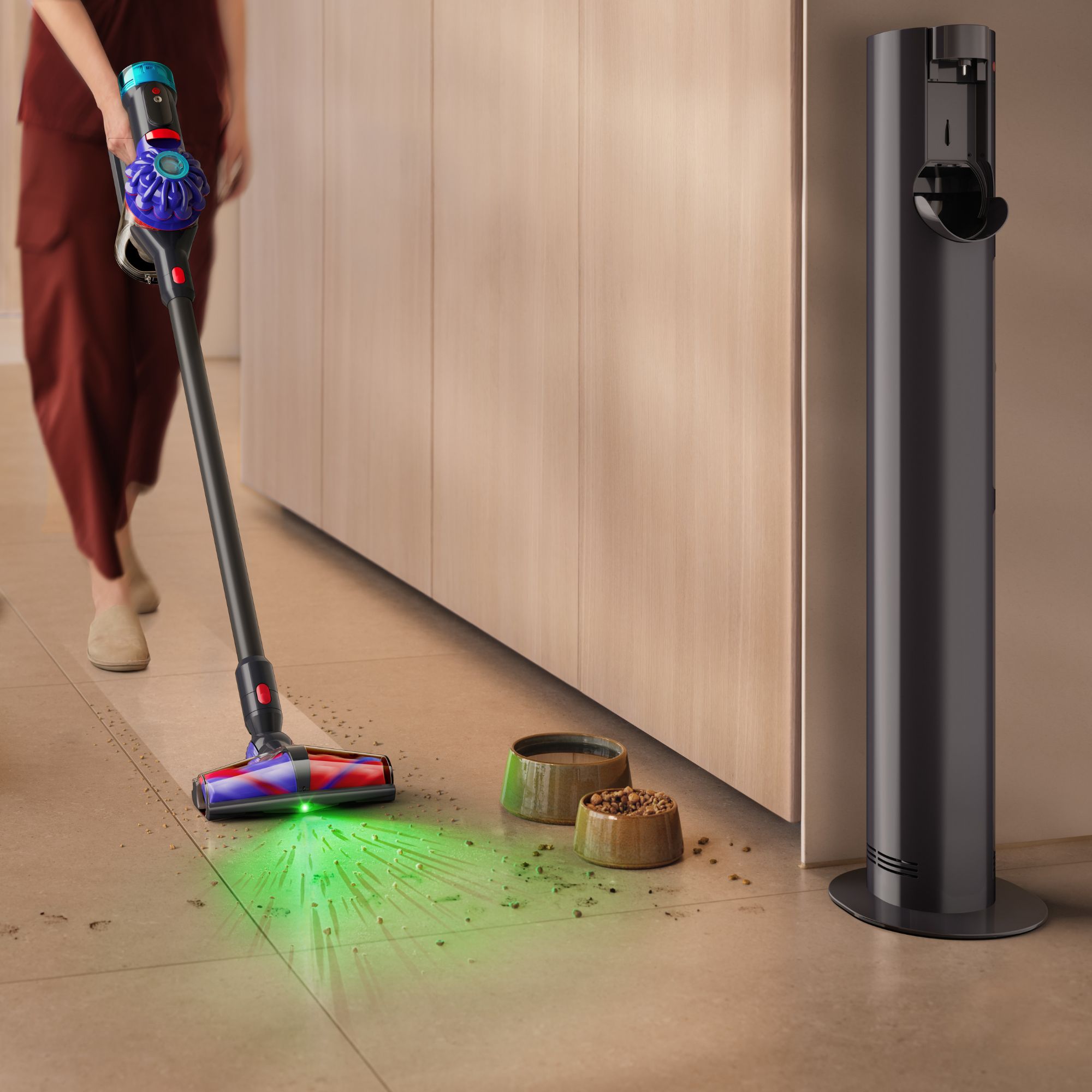 Someone using the Dyson V10 Konical to vacuum pet food from hardwood floors