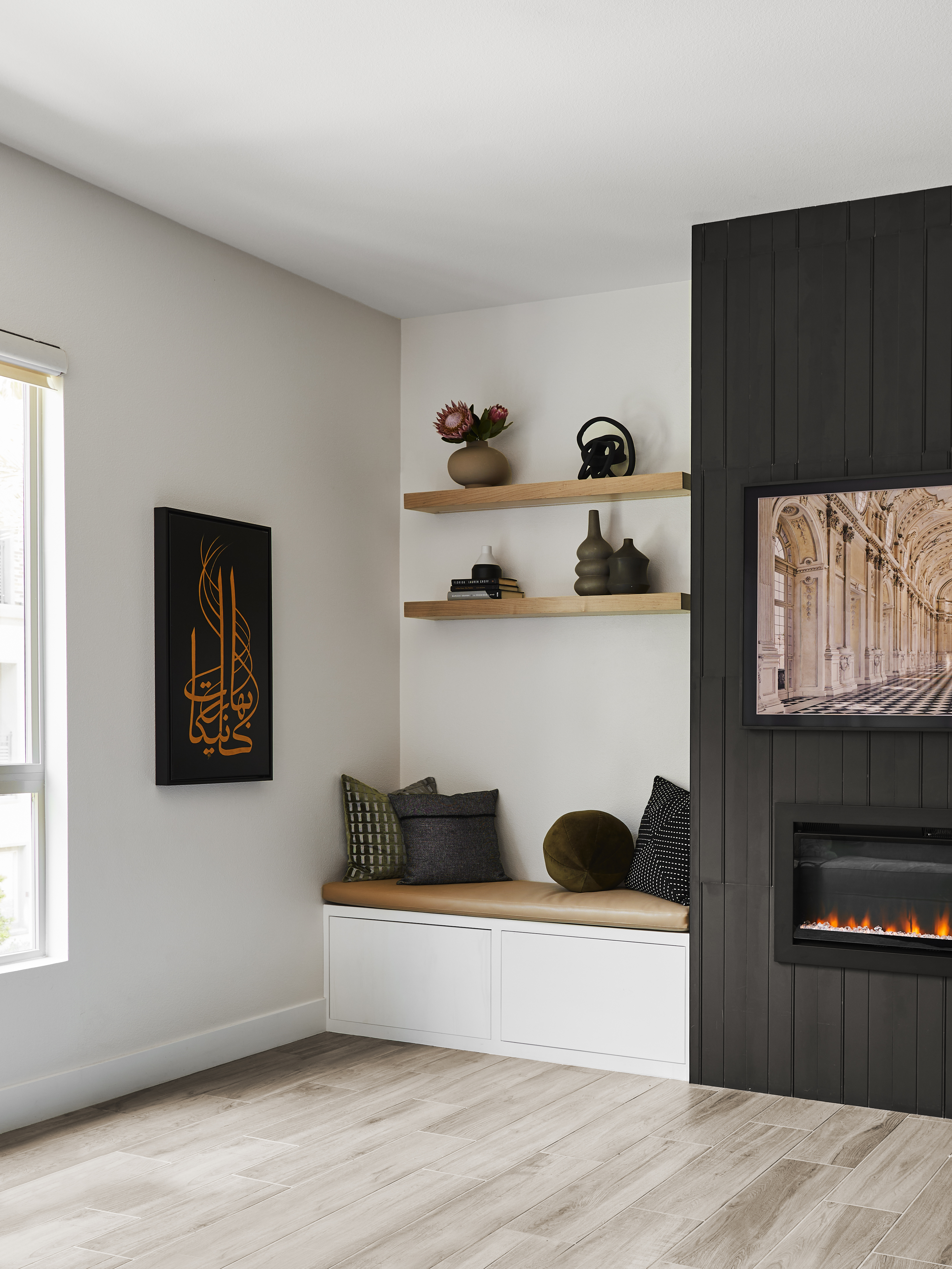 A small, built-in seat next to the fireplace