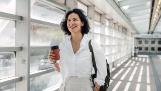 Woman holding coffee cup on way to work