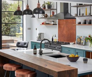 A newly designed kitchen with a central island made in composite stone and wood