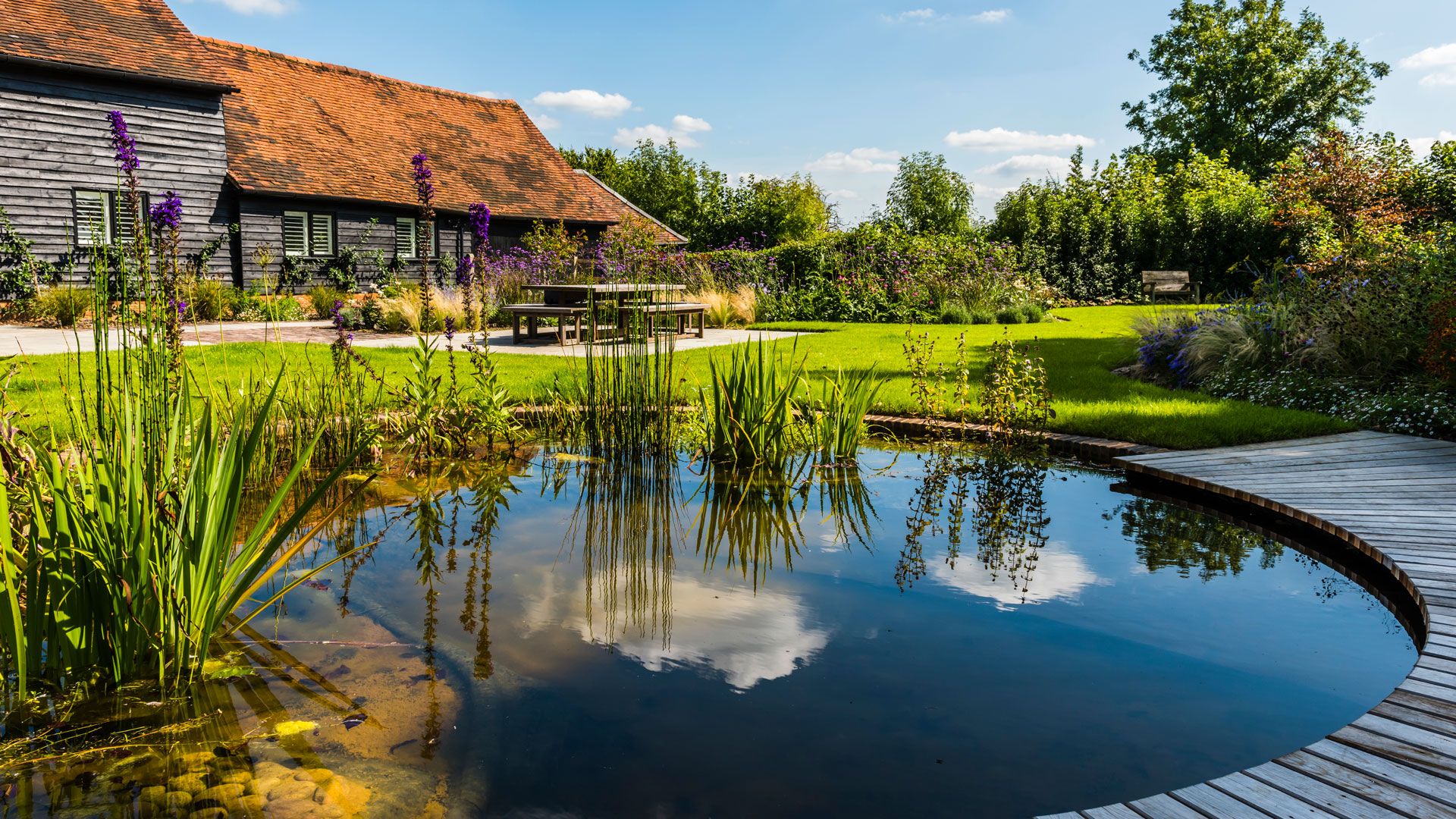 Barn conversion garden with natural pond