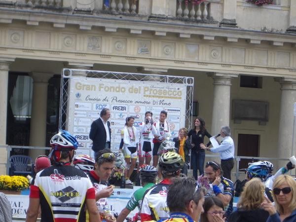 The women's Medio Fondo podium. That's not Champagne she's drinking!