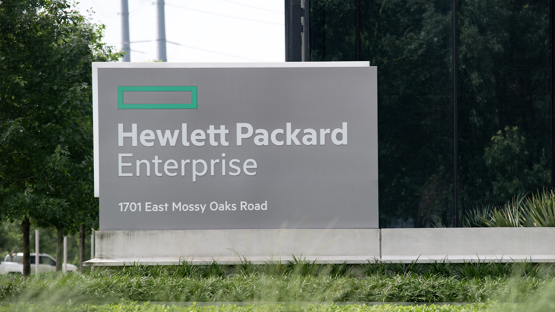 HPE logo and branding pictured on a sign at the company's global headquarters at East Mossy Oaks Road in Spring, Texas.