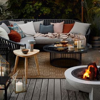 outdoor sitting area with sofa and fire pit