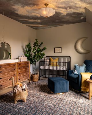 A child's nursery with ceiling wallpaper