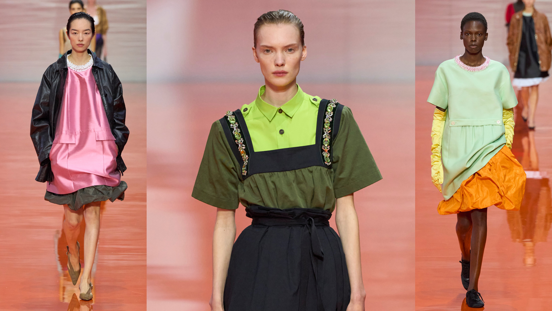 three models walking the Prada runway wearing dresses with jewel embellished collars