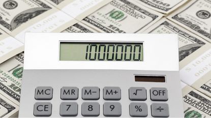 A calculator on top of stacks of cash shows 1,000,000.