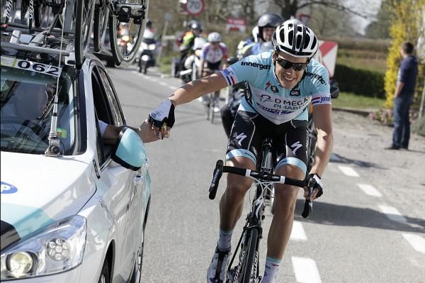 Niki Terpstra gets a turbo bottle from the Omega Pharma-Quickstep car