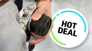 Fujifilm X-M5 being held in man's hand with Hot Deal flash