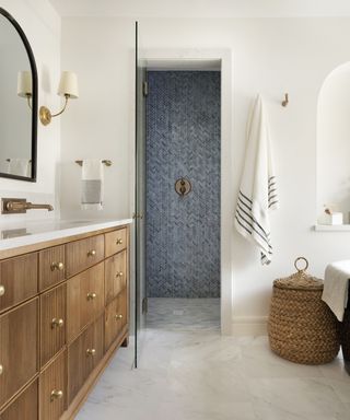 white bathroom with wooden vanity with brass knobs