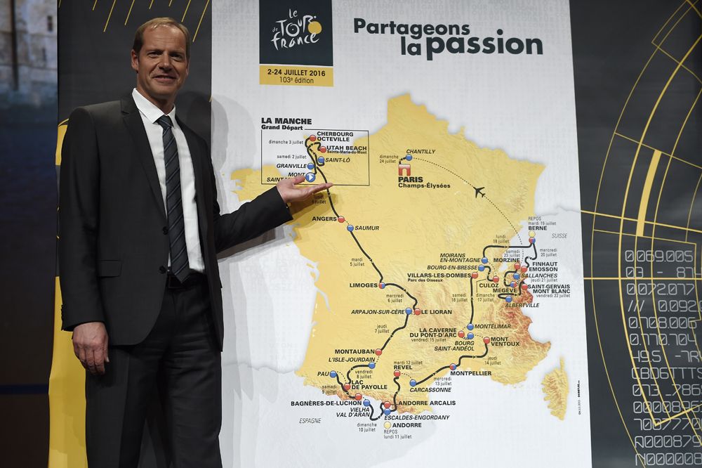 Christian Prudhomme stands next to the map of the 2016 Tour de France route