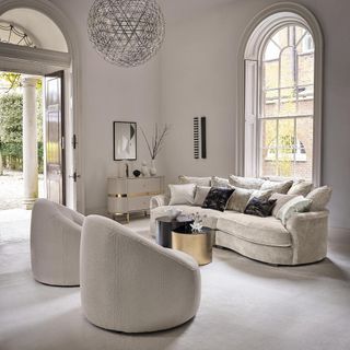 white living room with sofa and armchairs