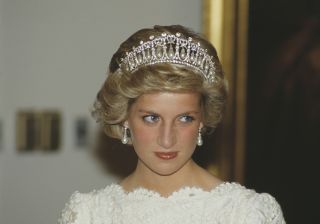 Princess Diana wears a white dress and a tiara with pearl earrings