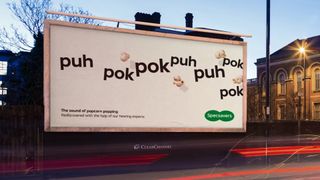Specsavers billboard ad featuring text that reads "the sound of popcorn popping" 