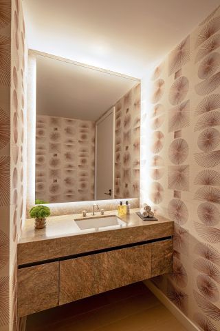 A powder room with patterned wallpaper