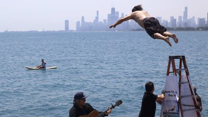 Dan O'Conor jumps into Lake Michigan.
