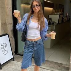 Woman in white tank top and jorts