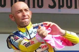 Pantani pulling on the Giro d'Italia leader's pink jersey at Borgo San Dalmazzo in 1999