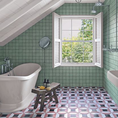 Bathroom with green tiles on walls and geometric tiles on floors