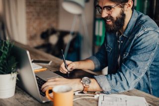 man at laptop organizing image library