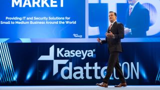 Kaseya CEO Fred Voccola walking across a stage at Kaseya DattoCon Europe 2023