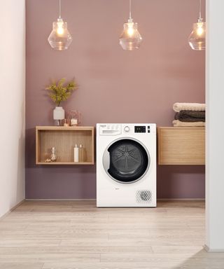 A tumble dryer in pink room