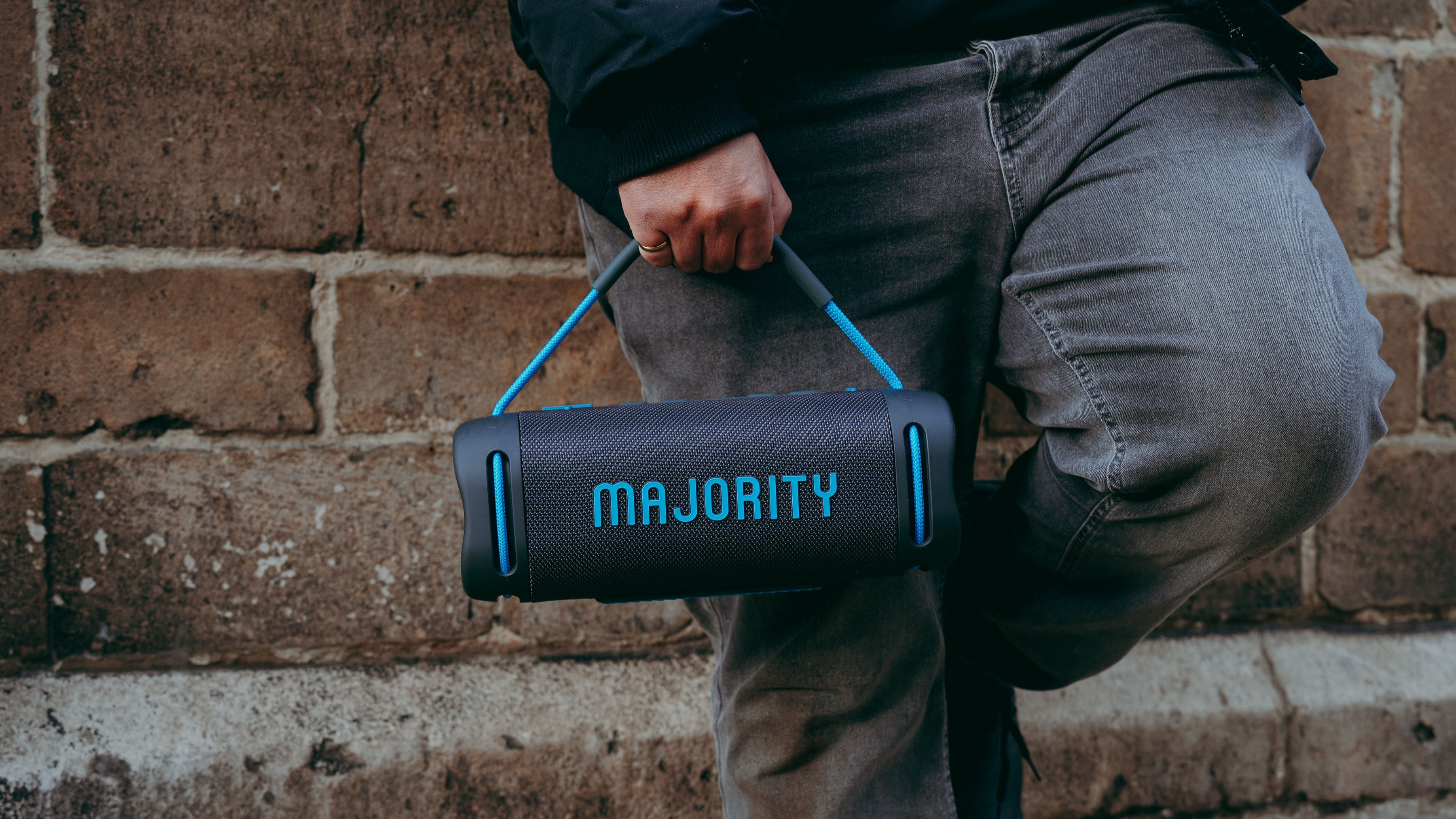 Majority Move M4 Bluetooth speaker being held by the carry handle