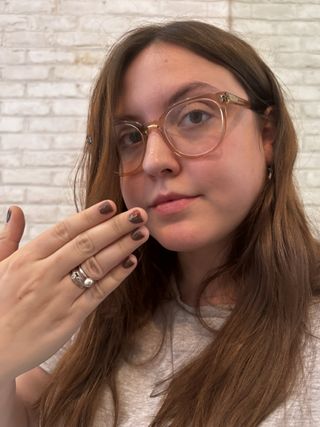 Sophia Vilensky showing off her chocolate brown BIAB nails manicure.