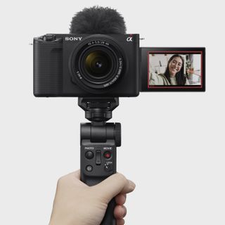 Sony ZV-E1 full-frame vlog camera held up and with face on screen