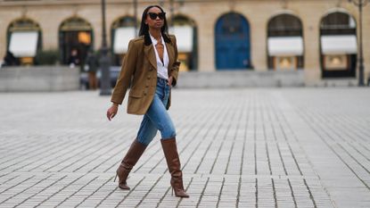 woman wearing a blazer and stiletto boots