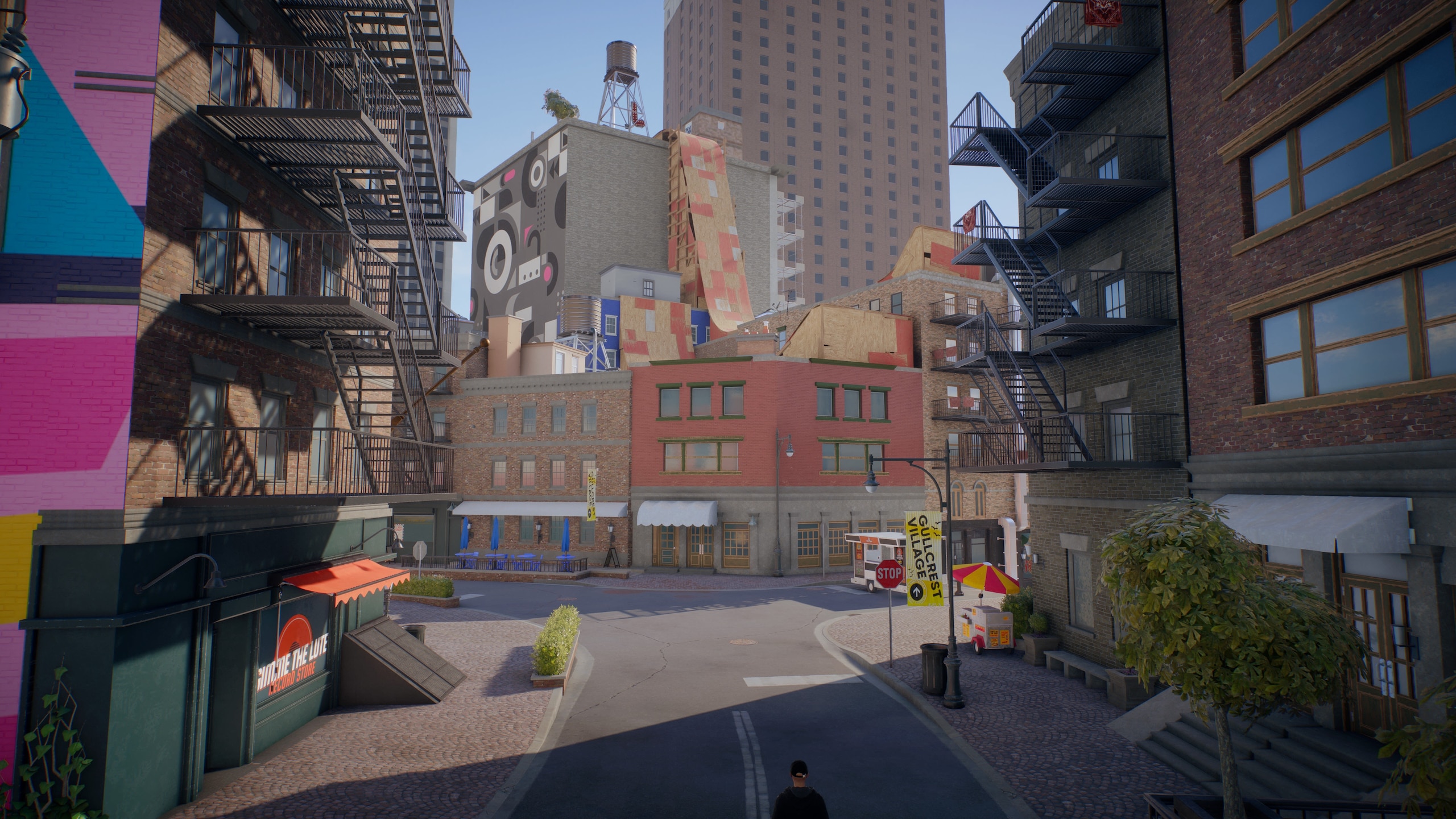 An area of SanVansterdam: Colorful buildings with large ramps on rooftops and a skyscraper in the distance