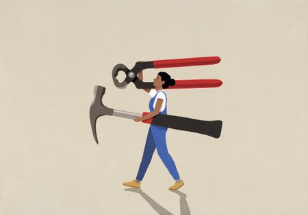 DIY woman in overalls carrying large tools on beige background
