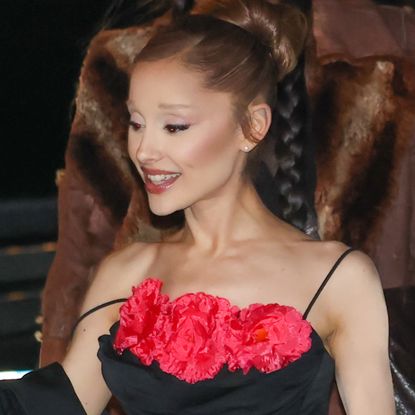 Ariana Grande attended the Wicked Paris premiere in a black gown with satin "Glinda" pink accents