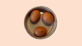 Three eggs sitting in a bowl