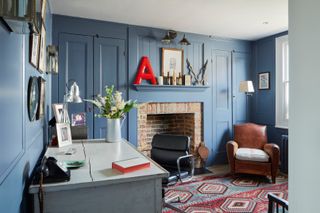 sitting room with fireplace, leather chair and red letter A
