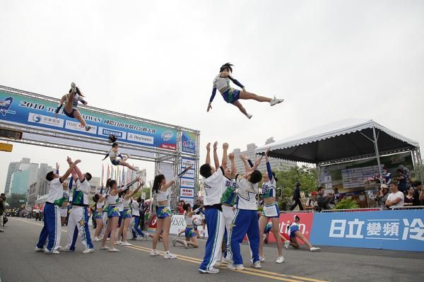 Acrobats entertain the crowd during the Tour de Taiwan.