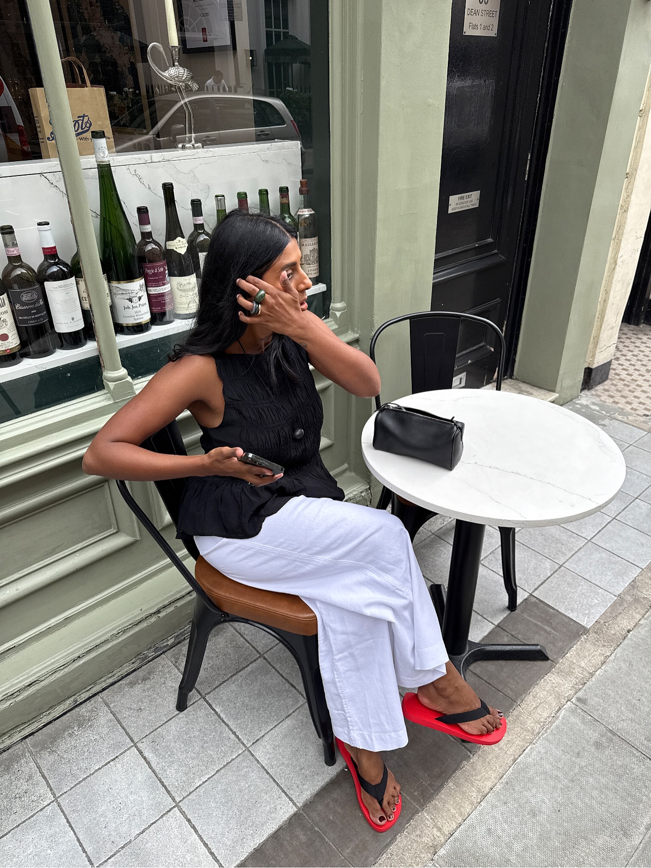 An image of @monikh wearing The Row Dune flip flop sandals, one of the 'it' sandals of 2025.
