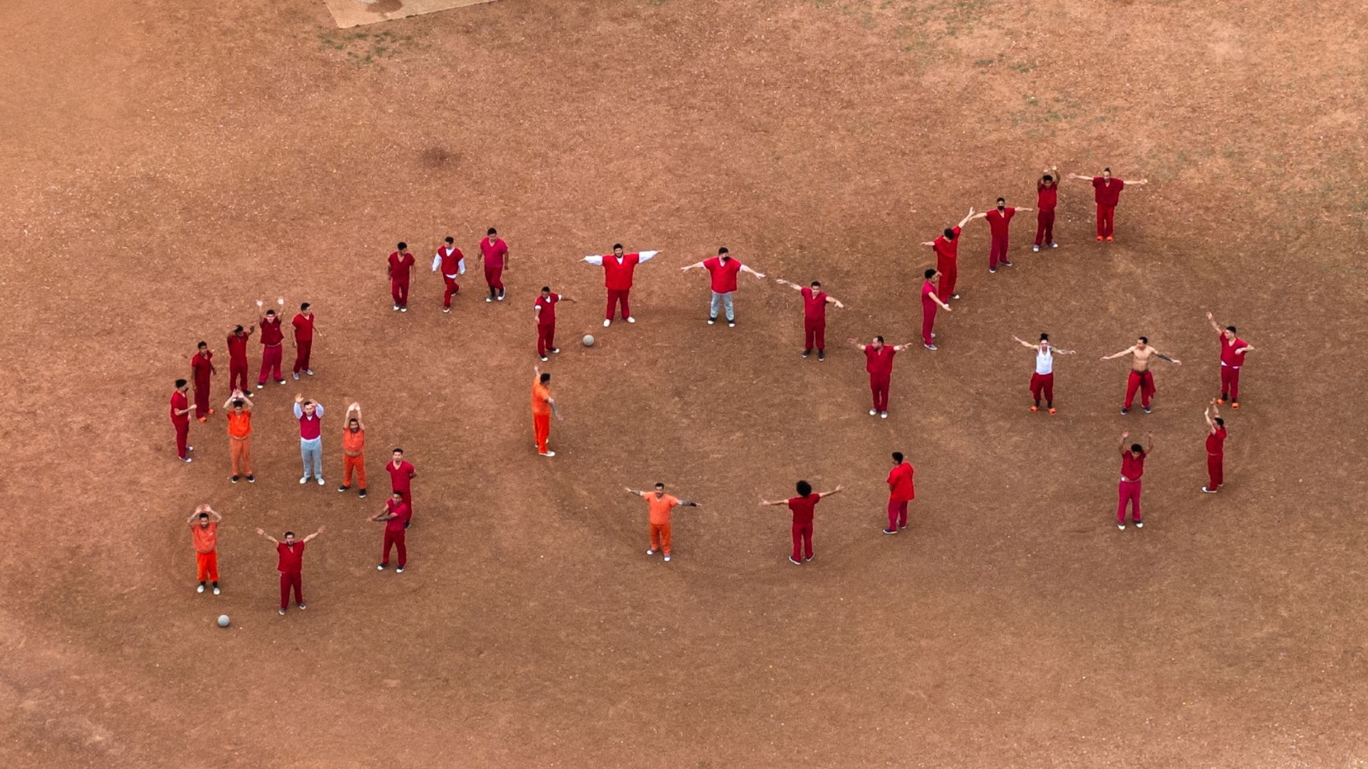 
                                Venezuelan immigrants arrange their bodies to form an SOS signal at the Bluebonnet Detention Facility in Anson, Texas
                            