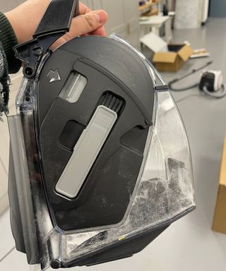 Closeup of the Miele Boost CX1 canister vacuum dustbin and small brush in Future test center