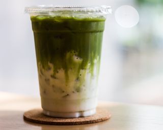 Iced matcha in plastic cup with lid