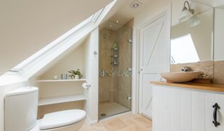 a loft conversion bathroom with storage under the eaves