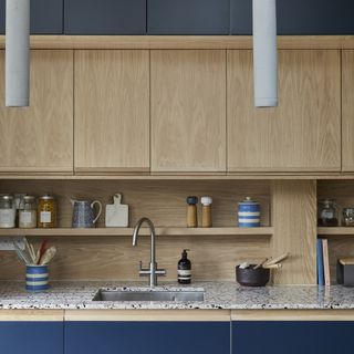 Navy and oak two tone kitchen with terrazzo worktop