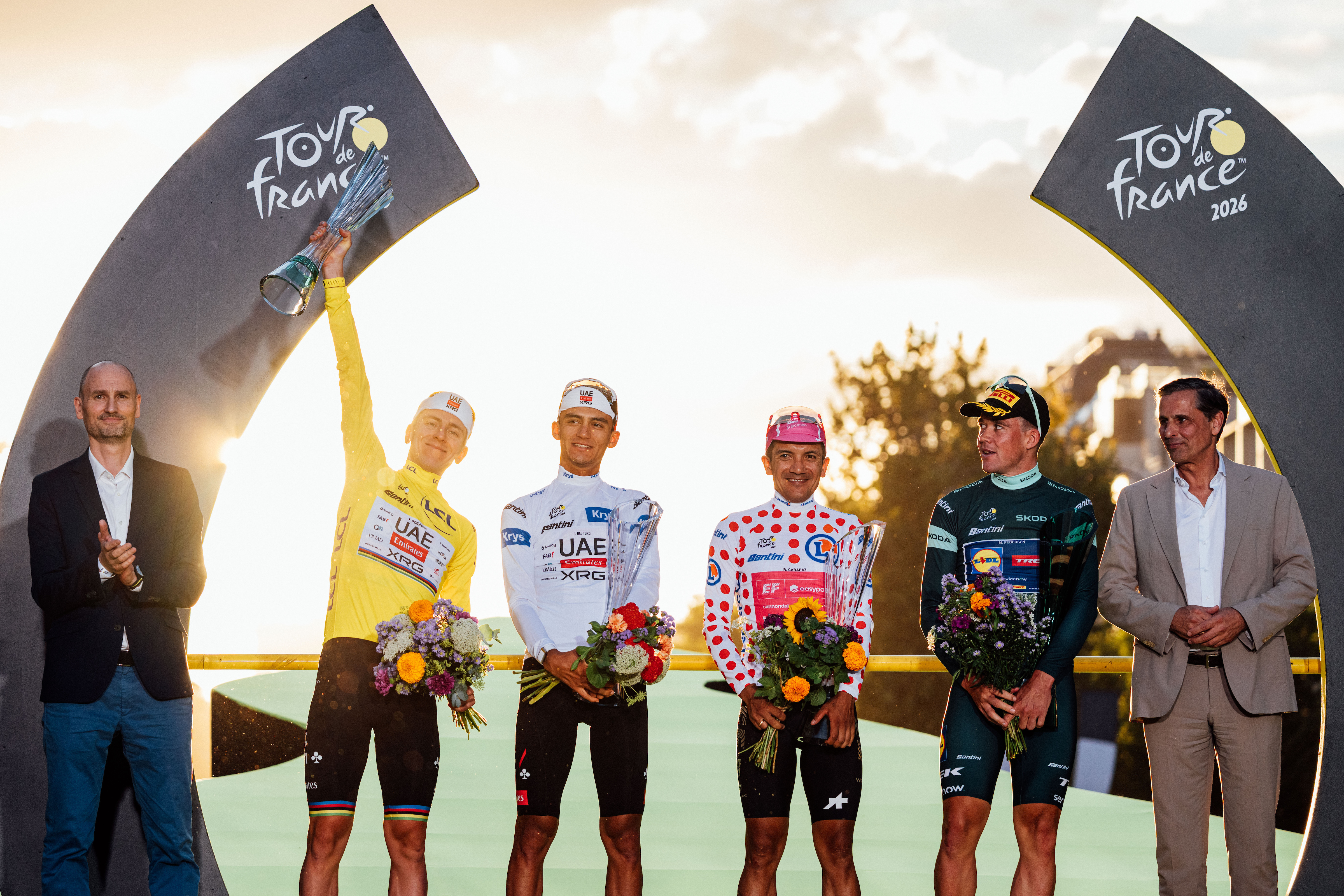 Tadej Pogačar, Isaac del Toro, Richard Carapaz and Mads Pedersen on the final podium of the 2026 Tour de France in Paris