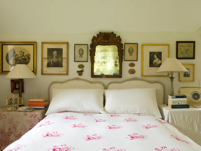 Cottage bedroom ideas - bedhead surrounded by antique accessories in cottage bedroom style
