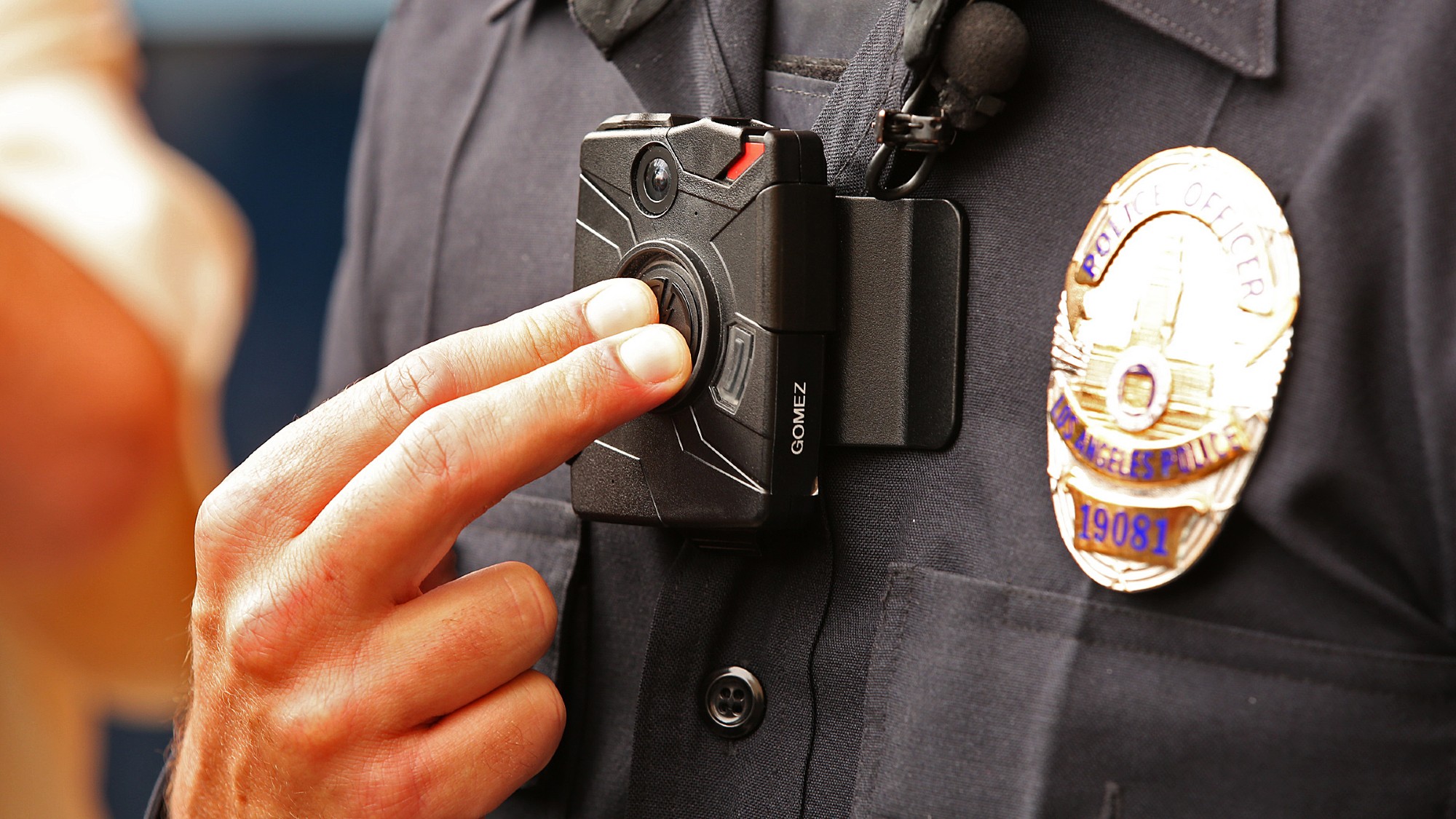 A Los Angeles Police Department officer adjusts his bodycam.
