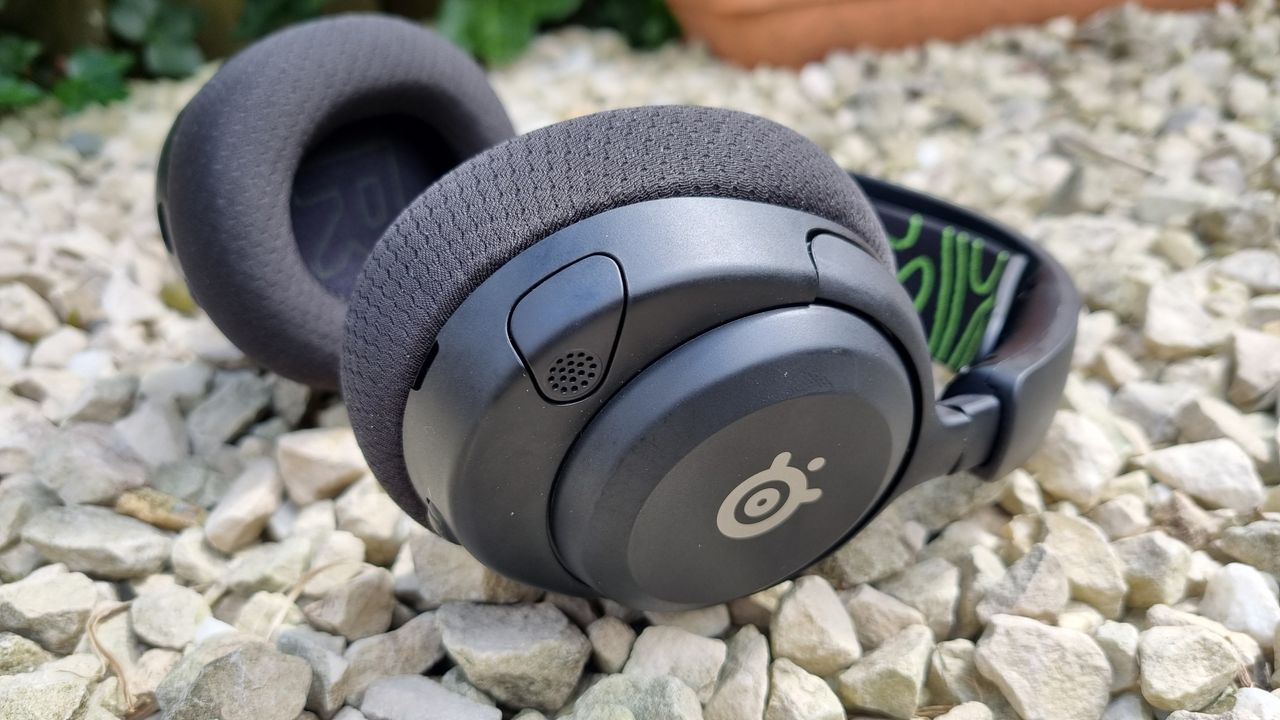 The left ear cup of the SteelSeries Arctis Nova 5X Wireless, showing the retracted, hidden microphone