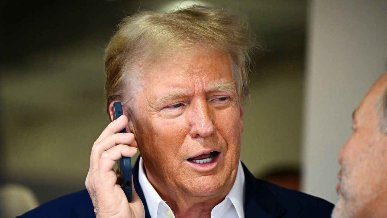 Donald Trump talks on a cellphone at Miami F1 race