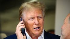 Donald Trump talks on a cellphone at Miami F1 race