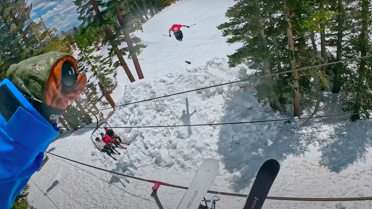 Skiers jump over chair lift