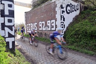 Riders speed through the 'Pont Gibus' sector 18 in Wallers